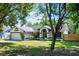 Well-kept one-story home with a two-car garage, manicured lawn, and arched entryway, exuding curb appeal at 485 Sandpiper Ridge Dr, Orlando, FL 32835