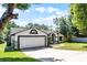 Charming one-story home with a well-maintained lawn, a white exterior, and an attached two-car garage at 485 Sandpiper Ridge Dr, Orlando, FL 32835