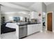 Modern kitchen with stainless steel appliances, granite countertop, and mosaic tile backsplash open to living area at 485 Sandpiper Ridge Dr, Orlando, FL 32835