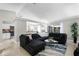 Open-concept living room with a large sectional sofa, modern decor, and seamless flow to the kitchen at 485 Sandpiper Ridge Dr, Orlando, FL 32835