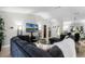 Bright living room with a large sofa, contemporary decor, and an open layout connecting to the dining space at 485 Sandpiper Ridge Dr, Orlando, FL 32835