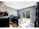 Home office with dark gray walls and sliding doors leading to the backyard at 485 Sandpiper Ridge Dr, Orlando, FL 32835