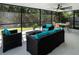 Screened patio with wicker seating, ceiling fan, and view of backyard at 485 Sandpiper Ridge Dr, Orlando, FL 32835