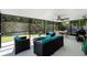 Screened patio with wicker seating, ceiling fan, and dining area overlooking lush backyard at 485 Sandpiper Ridge Dr, Orlando, FL 32835