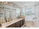 Bright bathroom featuring a dual vanity, soaking tub, and mosaic tile accents at 506 Pineloch Dr, Haines City, FL 33844