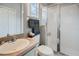 Practical bathroom featuring a glass-enclosed shower and ample counter space at 506 Pineloch Dr, Haines City, FL 33844