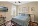 Cozy bedroom with hardwood floors, classic decor, and warm lighting at 506 Pineloch Dr, Haines City, FL 33844