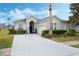 Charming single-story home with a well-maintained lawn, mature landscaping, and a long driveway at 506 Pineloch Dr, Haines City, FL 33844