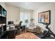 Bright home office featuring a modern desk, comfortable chair, and a Peloton exercise bike at 506 Pineloch Dr, Haines City, FL 33844