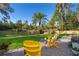 Lush backyard featuring a private lawn, palm tree, and outdoor seating area with patio at 516 Sanctuary Golf Pl, Apopka, FL 32712