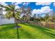 Expansive backyard with vibrant green grass, framed by a wooden fence for privacy at 516 Sanctuary Golf Pl, Apopka, FL 32712