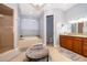 Bright bathroom featuring a soaking tub, walk-in shower, vanity, and elegant chandelier at 516 Sanctuary Golf Pl, Apopka, FL 32712