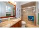 Inviting bathroom with wood vanity, granite countertops, framed mirror, and glass door shower at 516 Sanctuary Golf Pl, Apopka, FL 32712