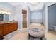 Bright bathroom featuring a soaking tub, walk-in shower, vanity, and elegant chandelier at 516 Sanctuary Golf Pl, Apopka, FL 32712