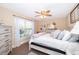 Serene bedroom featuring a bed, ceiling fan, and a large window overlooking the backyard at 516 Sanctuary Golf Pl, Apopka, FL 32712