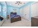 Cozy blue bedroom with a bed, ceiling fan, and storage, perfect for a  at 516 Sanctuary Golf Pl, Apopka, FL 32712