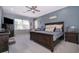 Main bedroom featuring a ceiling fan, a large bed, and large windows with natural light at 516 Sanctuary Golf Pl, Apopka, FL 32712