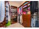 Walk-in closet with custom shelving and storage solutions for shoes, clothing, and accessories at 516 Sanctuary Golf Pl, Apopka, FL 32712