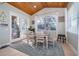 Cozy dining room with a wood ceiling, natural light, and seating for four around the table at 516 Sanctuary Golf Pl, Apopka, FL 32712