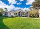 A single Gathering home featuring a well manicured lawn and stone accents at 516 Sanctuary Golf Pl, Apopka, FL 32712