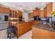 Bright kitchen featuring tile floors, granite counters, kitchen island, and stainless steel appliances at 516 Sanctuary Golf Pl, Apopka, FL 32712