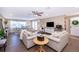 Spacious living room featuring hardwood floors, comfortable seating, and lots of natural light at 516 Sanctuary Golf Pl, Apopka, FL 32712