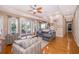 Spacious living room with crown molding, recessed lighting and wood floors at 516 Sanctuary Golf Pl, Apopka, FL 32712
