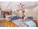 Living room featuring hardwood floors, gray sectional sofa, and ceiling fan at 516 Sanctuary Golf Pl, Apopka, FL 32712