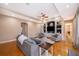 An open concept living room with wood floors and custom built-ins at 516 Sanctuary Golf Pl, Apopka, FL 32712