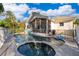 Backyard pool and spa area featuring a patio, safety fence, and screened-in porch at 516 Sanctuary Golf Pl, Apopka, FL 32712