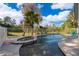 Backyard pool and spa area with a privacy fence and view of the natural landscape at 516 Sanctuary Golf Pl, Apopka, FL 32712
