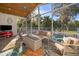 Enclosed sunroom with vaulted ceilings, comfortable seating, and views of the natural landscape at 516 Sanctuary Golf Pl, Apopka, FL 32712