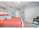 This bedroom features blue walls, coastal decor, and a queen bed with colorful pillows at 5300 S Atlantic Ave # 2-501, New Smyrna Beach, FL 32169