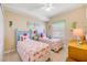 Charming bedroom with two twin beds featuring flamingo bedding, complemented by coastal decor and light, neutral walls at 5300 S Atlantic Ave # 2-501, New Smyrna Beach, FL 32169