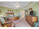 Spacious bedroom with a king bed, leaf-patterned bedding, wooden furniture, and an ensuite bathroom at 5300 S Atlantic Ave # 2-501, New Smyrna Beach, FL 32169