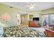 Bright bedroom with a king bed, leaf bedding, wooden furniture, and sliding glass doors to a balcony at 5300 S Atlantic Ave # 2-501, New Smyrna Beach, FL 32169