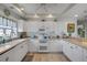 Charming kitchen with white cabinets, modern appliances, and beach-themed decor at 5300 S Atlantic Ave # 2-501, New Smyrna Beach, FL 32169
