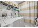 Well-lit laundry room featuring a white washer and dryer, and convenient overhead shelving for storage at 5300 S Atlantic Ave # 2-501, New Smyrna Beach, FL 32169