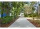 A long driveway leads to the house, framed by lush greenery and trees at 5340 Jones Rd, St Cloud, FL 34771