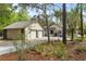 View of the rear exterior of the home and 2-car garage amidst lush greenery at 5340 Jones Rd, St Cloud, FL 34771