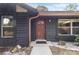 A detailed view of the front entry featuring a decorative wood door and meticulous landscaping at 5340 Jones Rd, St Cloud, FL 34771