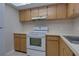 Functional kitchen with wood cabinets and modern appliances at 576 Fairways Ln # M103, Ocala, FL 34472