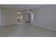 Inviting living room with neutral walls, tile floors, and an open concept leading into the kitchen at 576 Fairways Ln # M103, Ocala, FL 34472
