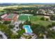 Aerial view of community amenities including a pool, baseball field, and football stadium at 600 Brechin Dr, Winter Park, FL 32792