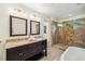 Bathroom with double sink vanity, granite countertop and elegant tiled walk-in shower at 600 Brechin Dr, Winter Park, FL 32792