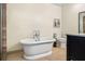 Bathroom with a free standing bathtub, tile floors and modern fixtures at 600 Brechin Dr, Winter Park, FL 32792