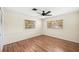 This bedroom offers hardwood floors, two windows with blinds, and a ceiling fan at 600 Brechin Dr, Winter Park, FL 32792