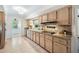 Functional kitchen with granite countertops, stainless steel appliances, wood cabinets, and tile flooring at 600 Brechin Dr, Winter Park, FL 32792