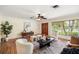 Inviting living room featuring hardwood floors, a ceiling fan, a neutral color palette, and lots of natural light at 600 Brechin Dr, Winter Park, FL 32792