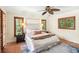 Bright main bedroom featuring hardwood floors, plantation shutters, and a ceiling fan at 600 Brechin Dr, Winter Park, FL 32792